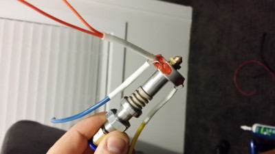 Hot end assembled.  Notice how the tip wasn't screwed in?  Well I sure didn't.  Did a couple test prints before I did notice.  Luckily nothing bad happened, but I did need to reset my Z.  But that's later.