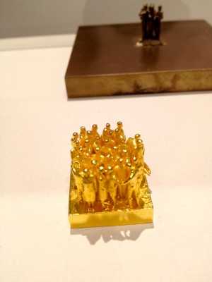 Prolific sculptor Do Ho Suh, these were a model for a larger sculpture, I think they were printed in resin and then cast. The final piece has approximately 50,000 of these small figures. Scale=I could probably fit about two figures on my thumbnail