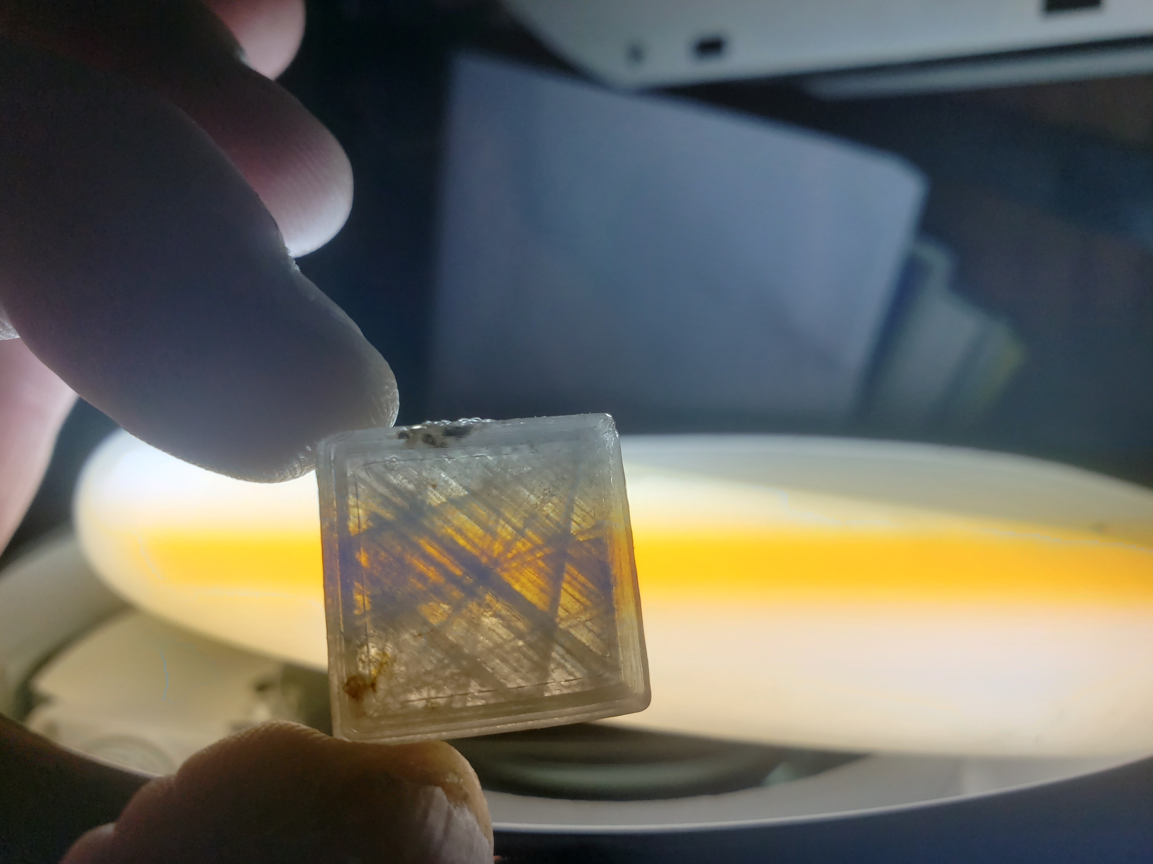 Test square held up to flourescent bulb